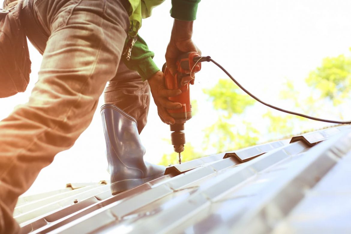 A professional from Hermitage Roofing repairs a client's metal roof.